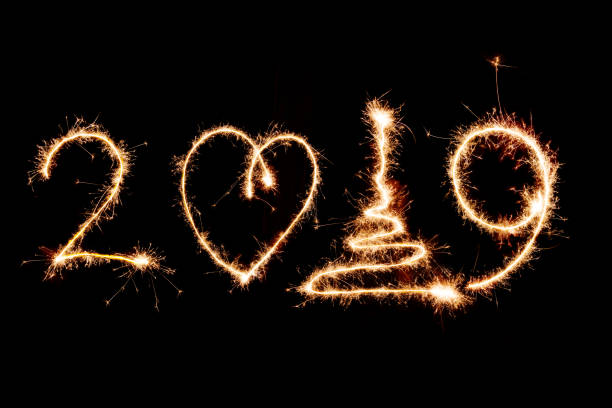 istock 2019 written with Sparkle firework on black background, happy new year 1071123906