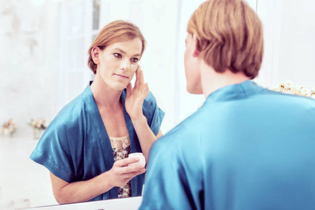 istock Attractive good-looking trans male having peaceful evening at home 1071126252