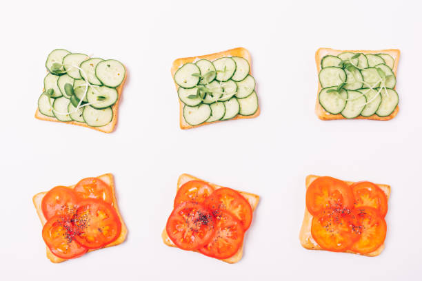 istock Flat lay composition toasts with green cucumbers and microgreens 1071128422