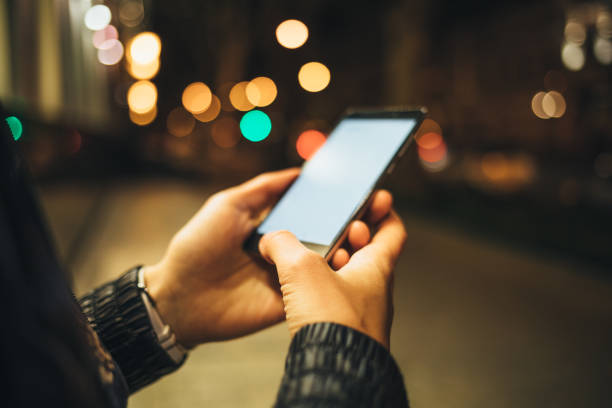 istock Close-up woman's hands holding mobile phone with blank touch screen 1071128438