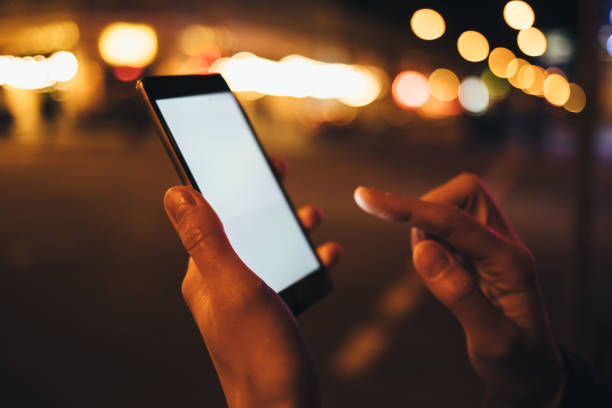 istock Close-up young woman's hands holding touching mobile phone 1071130064