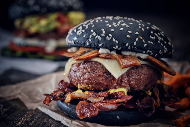 istock Black Burger Buns with Beef Pattie, Cheese, Tomato and Lettuce 1071135648