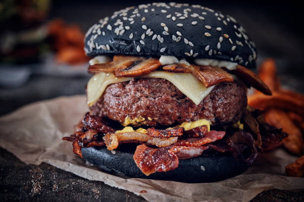 istock Black Burger Buns with Beef Pattie, Cheese, Tomato and Lettuce 1071135650
