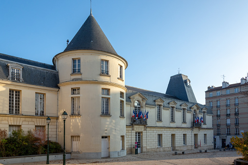Town hall of Clamart, France, with french and european flags, blue sky