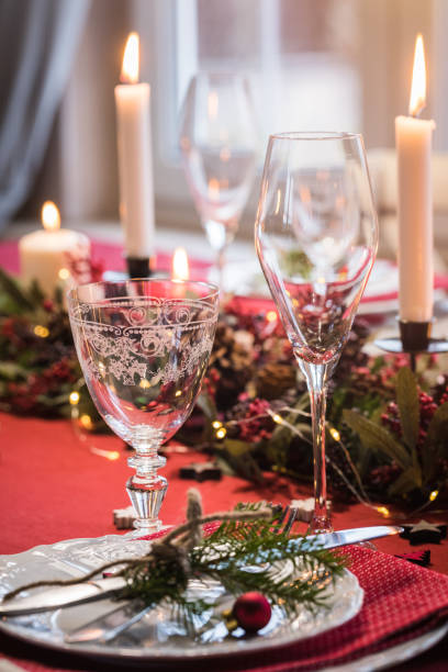 istock Table served for Christmas dinner, festive setting with decorations, burning candles and fir-tree branches 1071142850
