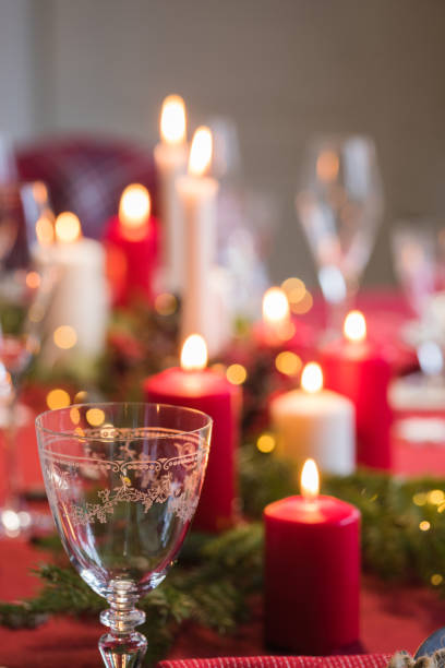 istock Table served for Christmas dinner, festive setting with decorations, burning candles and fir-tree branches 1071142878