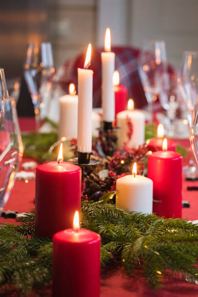 istock Table served for Christmas dinner, festive setting with decorations, burning candles and fir-tree branches 1071142880