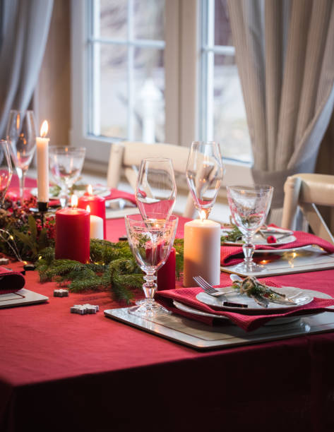 istock Table served for Christmas dinner, festive setting with decorations, burning candles and fir-tree branches 1071142920