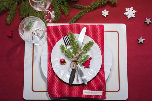 istock Christmas festive table setting with fir-tree branch and glasses 1071142952