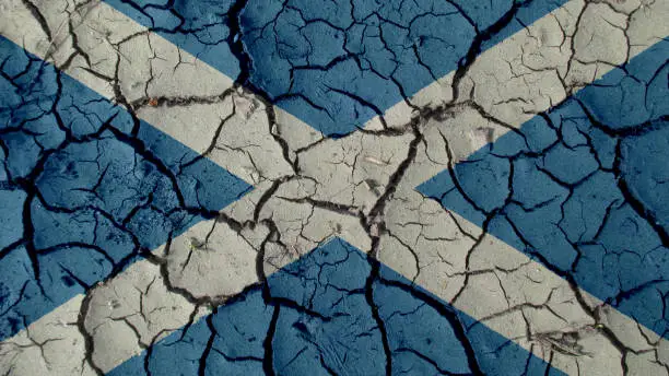 Political Crisis Or Environmental Concept: Mud Cracks With Scotland Flag