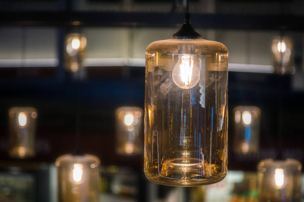 istock Vintage decorative light lamp bulb glowing on the ceiling indoors 1071147152