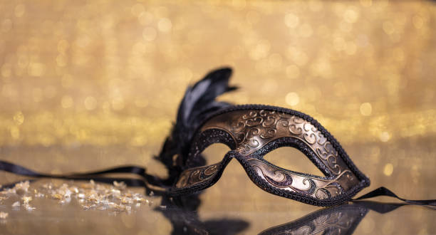 istock Carnival mask with feathers on golden bokeh background 1071149036