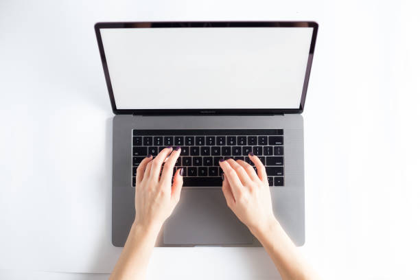 istock Lap top topview with hands on white background 1071149684