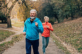 Senior couple jogging outdoors