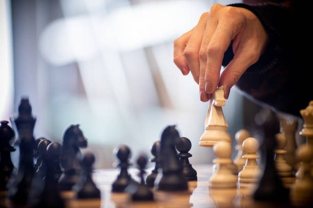 istock Hand moving the king in chess game 1071156000