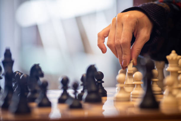 istock Hand moving the king in chess game 1071156180