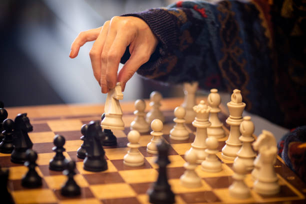 istock Hand moving the king in chess game 1071156248