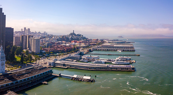 San Francisco, USA - September 04, 2018: Beautiful aerial view of the San Francisco docks with many piers including pier 39 and Alcatraz prison in the middle of the bay.