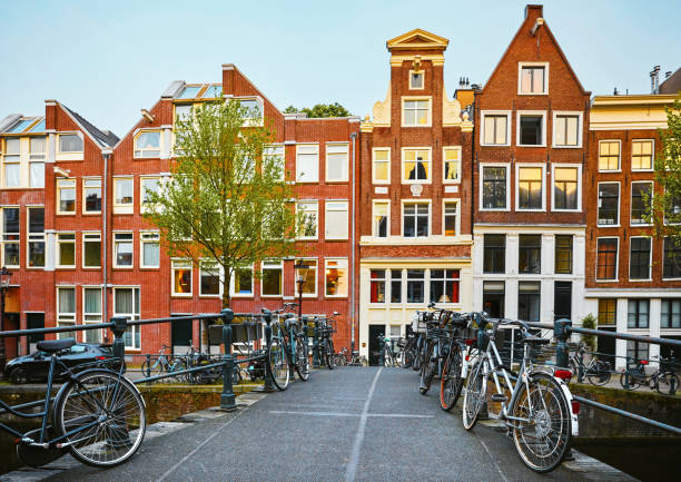 istock Amsterdam, Netherlands. Bridge with bicycles and houses 1071166846