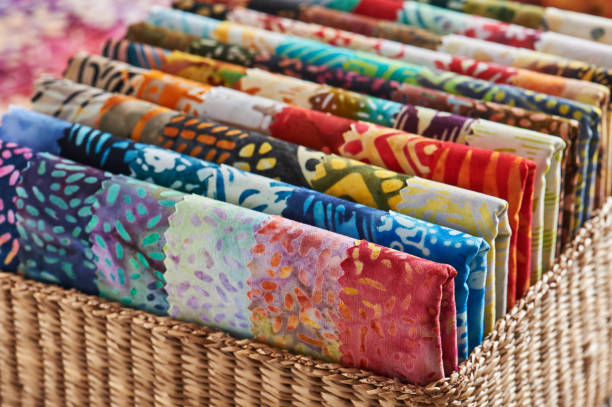 istock Folded bright pieces of quilting batik fabrics in a basket, macro 1071175512