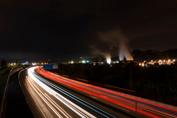 Highway Night Traffic Light Trails and Polluting Industries