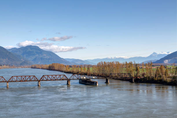 railway bridge across Fraser River between Mission and Abbotsford, BC, Canada railway bridge across Fraser River between Mission and Abbotsford, BC, Canada abbotsford canada stock pictures, royalty-free photos & images