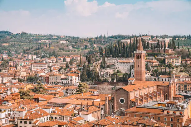 Verona, Italy. April 10, 2018. Aerial view of the old town of Verona with amazing narrow streets, orange rooftops and people in the center of the city.