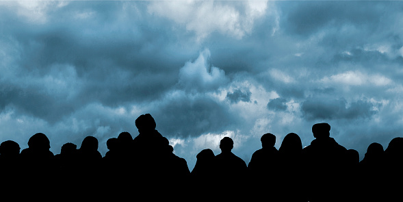 Graphic concept background design with group of people silhouette over stormy blue sky background