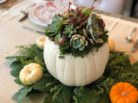 A beautiful fall centerpiece on a Thanksgiving dinner table.