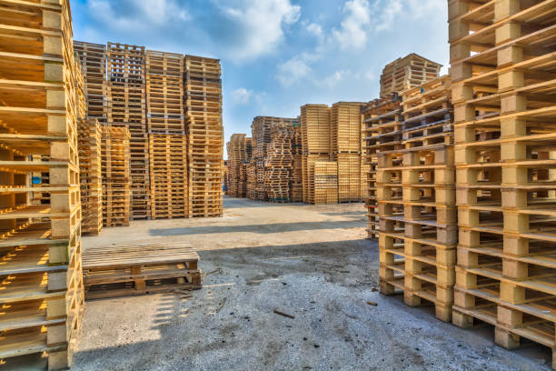 Piles of euro type cargo pallets Piles of euro type cargo pallets at a recycling business area pallet industrial equipment stock pictures, royalty-free photos & images