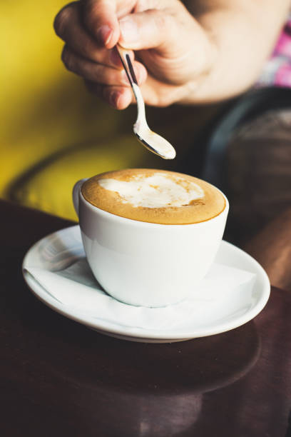 istock Pouring brown sugar in coffee and stirring up 1071207996