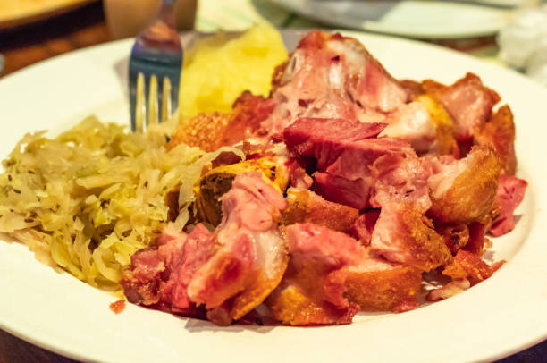 istock German pork fried with vegetables on a white plate 1071217396