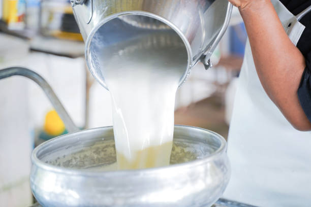 istock Worker pouring milk into  the container tank for transform. 1071219446