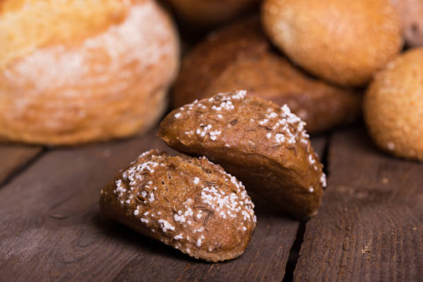 istock different fresh bread and buns on the wooden table