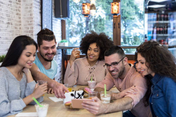istock Young people taking selfie with smart phone in cafe 1071221012