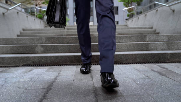 istock Office worker leaving business center walking down stairs unsuccessful interview 1071225242