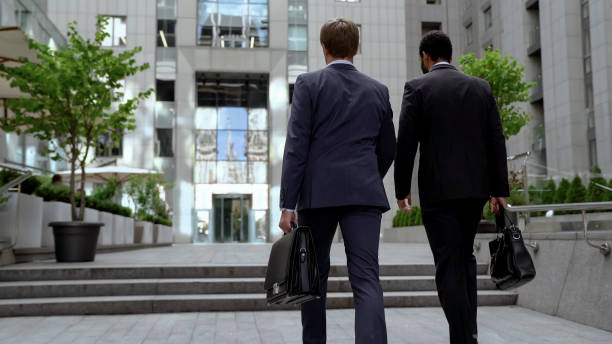 istock Colleagues approaching office building, discussing business project, cooperation 1071225638