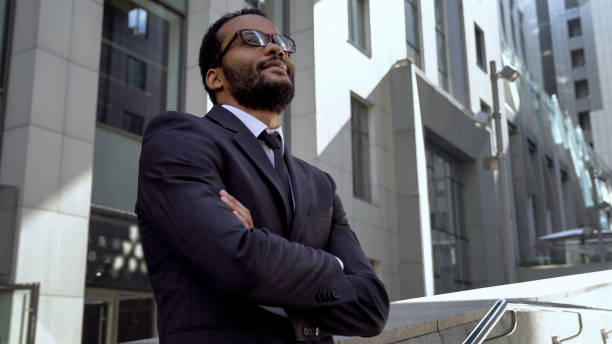 istock African office worker standing near modern office building, getting promotion 1071225696