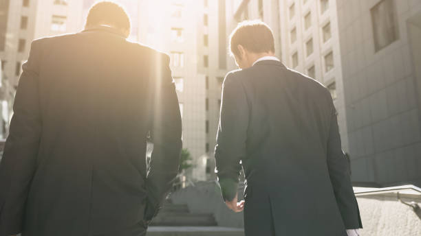 istock Two businessmen discussing contract, approaching office center, mutual interest 1071225744