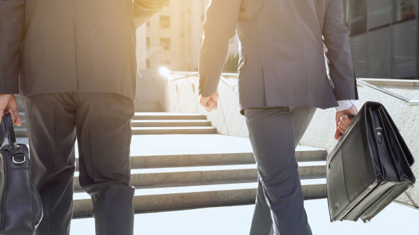 istock Office employees climbing upstairs, discussing startup, success in teamwork 1071225752