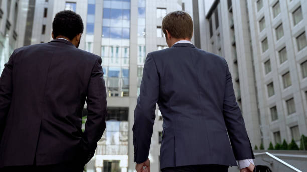 istock Multiracial colleagues approaching business center, discussing project success 1071225790