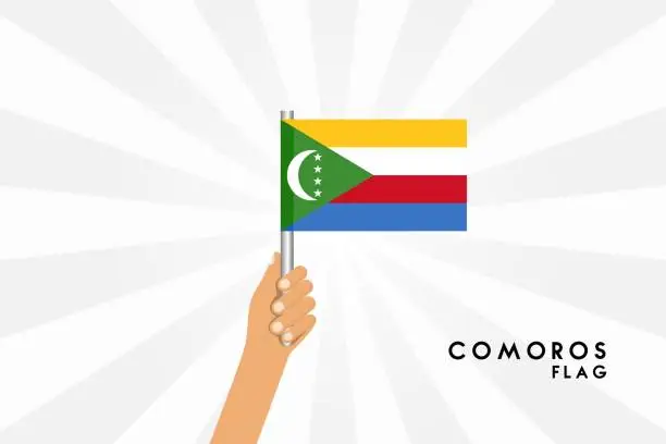 Vector illustration of Vector cartoon illustration of human hands hold Comoros flag. Isolated object on white background.