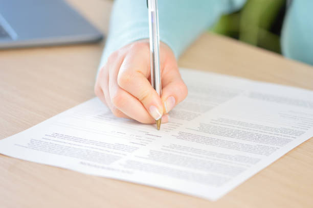 istock woman hand signing a document 1071236154