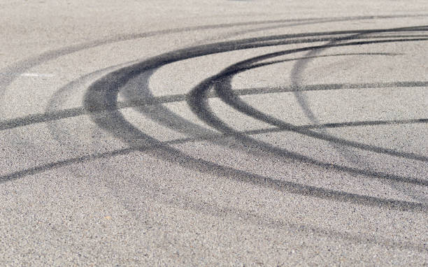 Round mark Close-up of several tire skid marks on asphalt asphalt stock pictures, royalty-free photos & images