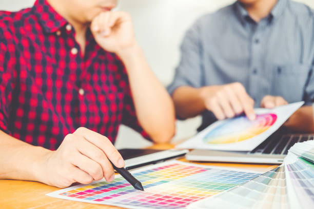 istock Two Graphic designer Brainstorming Meeting and drawing on graphics tablet at workplace 1071237912