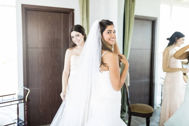 istock Young Woman Getting Dressed For Wedding Ceremony 1071242670