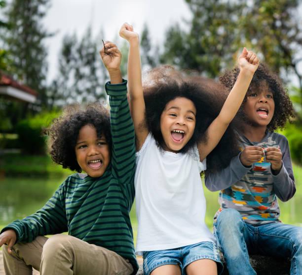 istock Happy kids group playing in the park in school. 1071244122