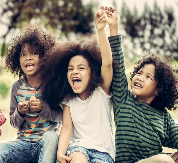 istock Happy kids group playing in the park in school. 1071244134