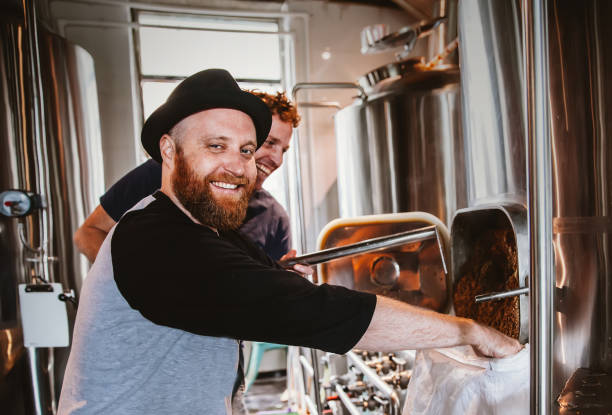 istock Male worker operating machinery in brewery 1071247638