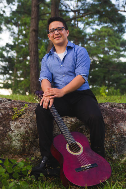 istock Man playing guitar in the forest 1071248776